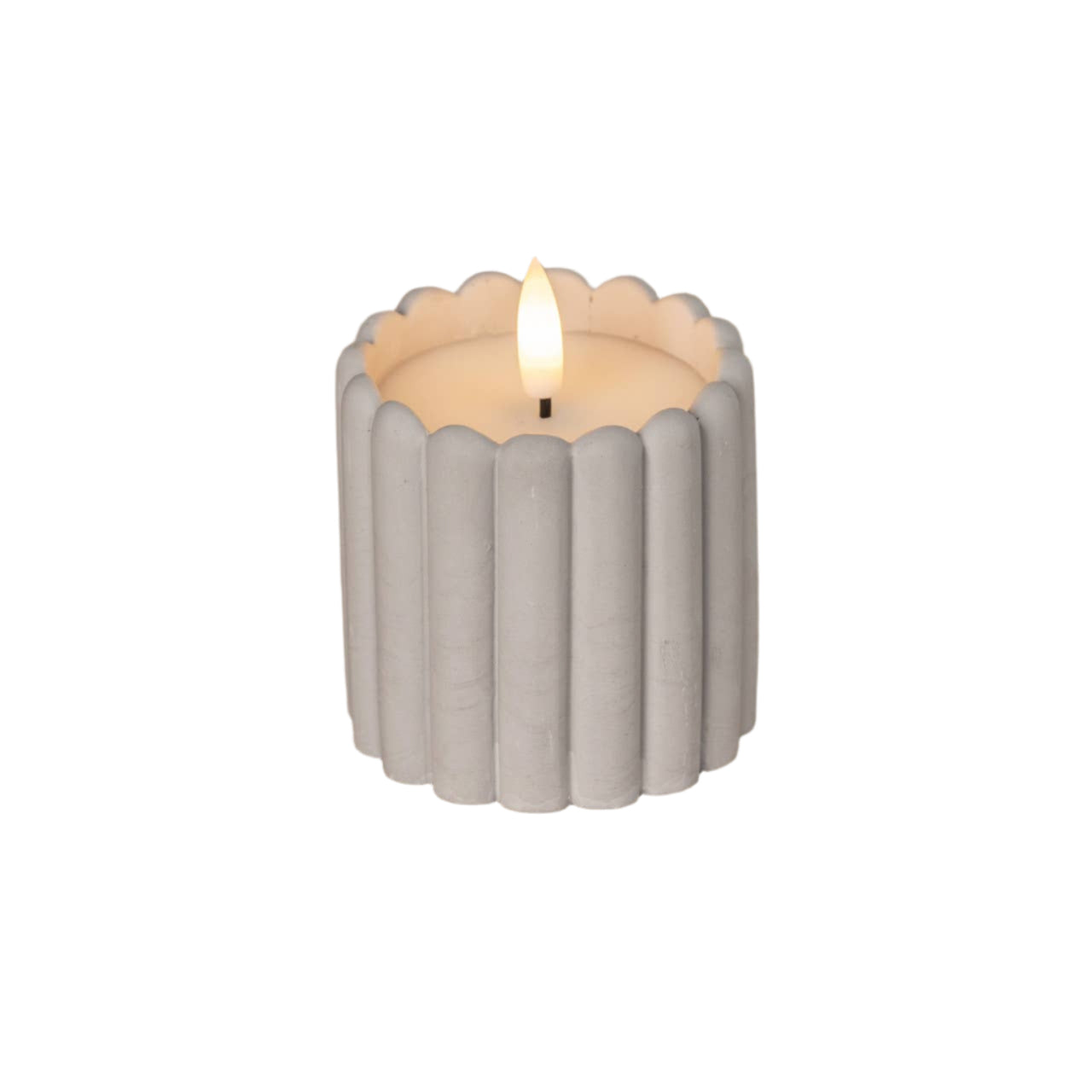 Candle in a ribbed concrete holder on a wooden surface