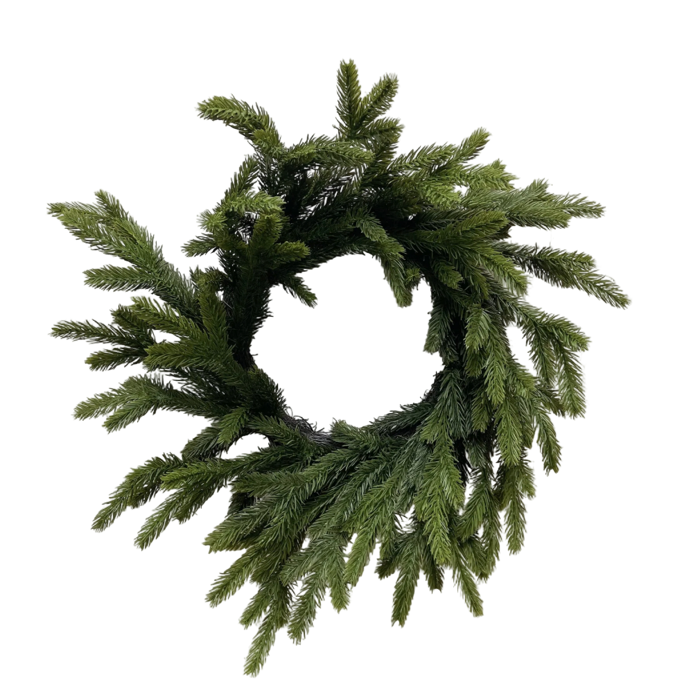 Green wreath on a white brick wall