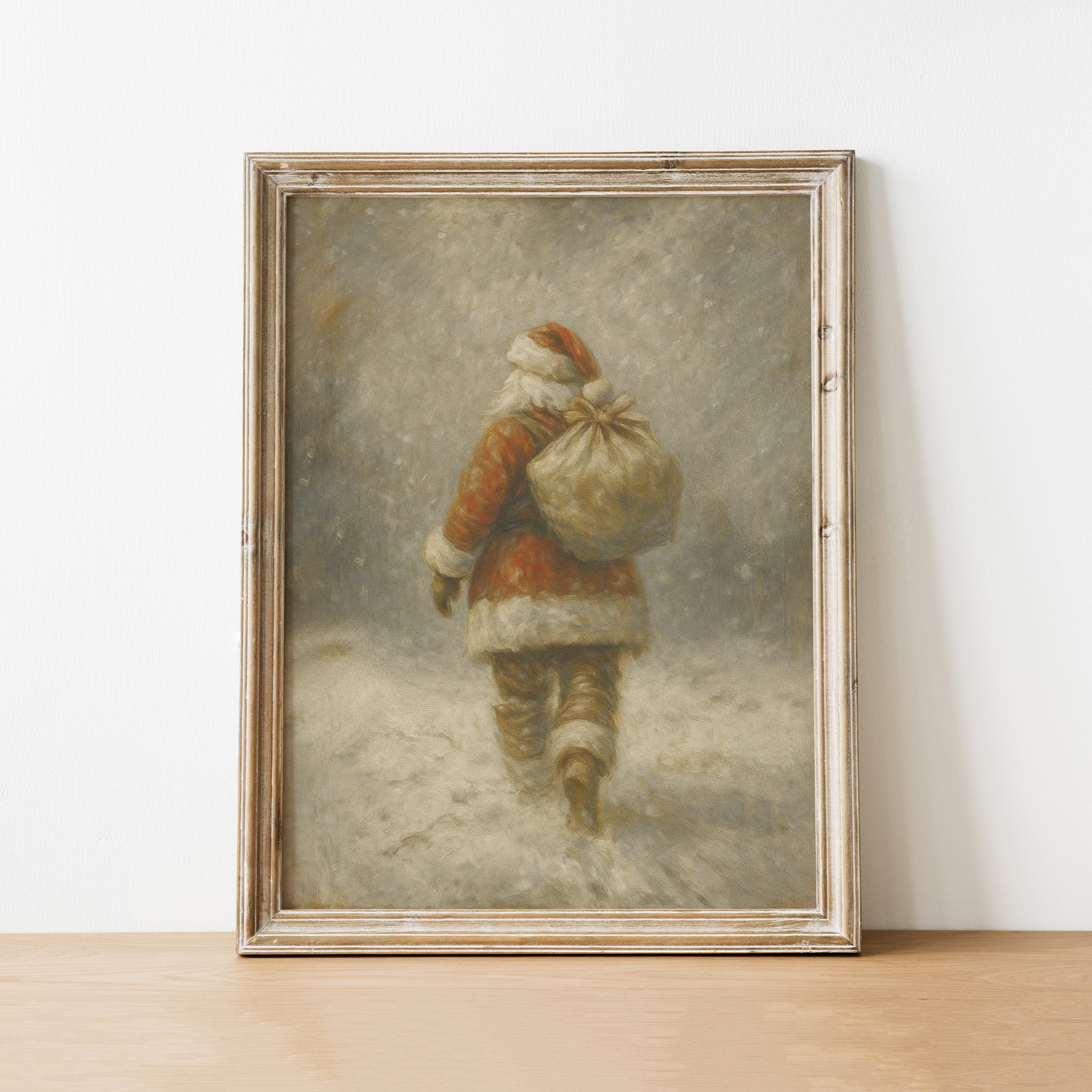 Framed painting of a person in winter attire with a large bag, leaning against a white wall.