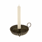 Decorative candle holder with a white candle on a white background
