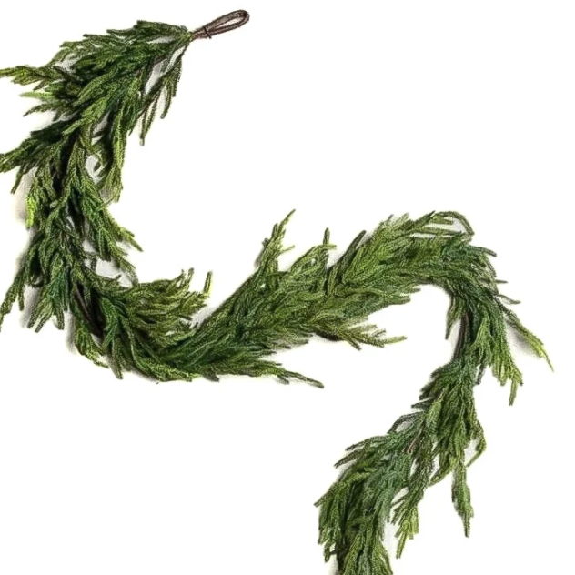 A green artificial evergreen garland with dense, needle-like foliage, shown on a plain white background.
